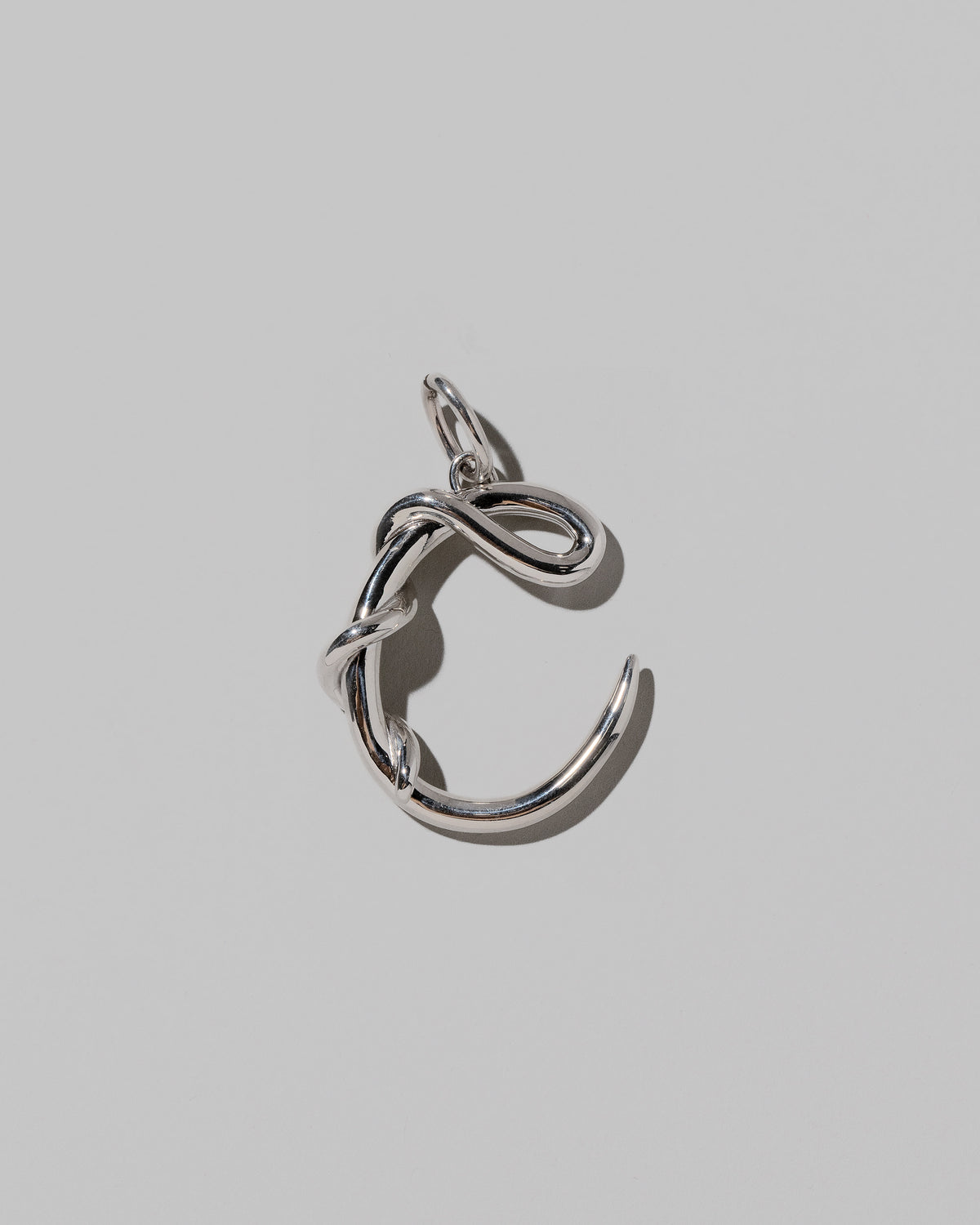 CRZM Large Letter C Charm set in sterling silver on light color background.
