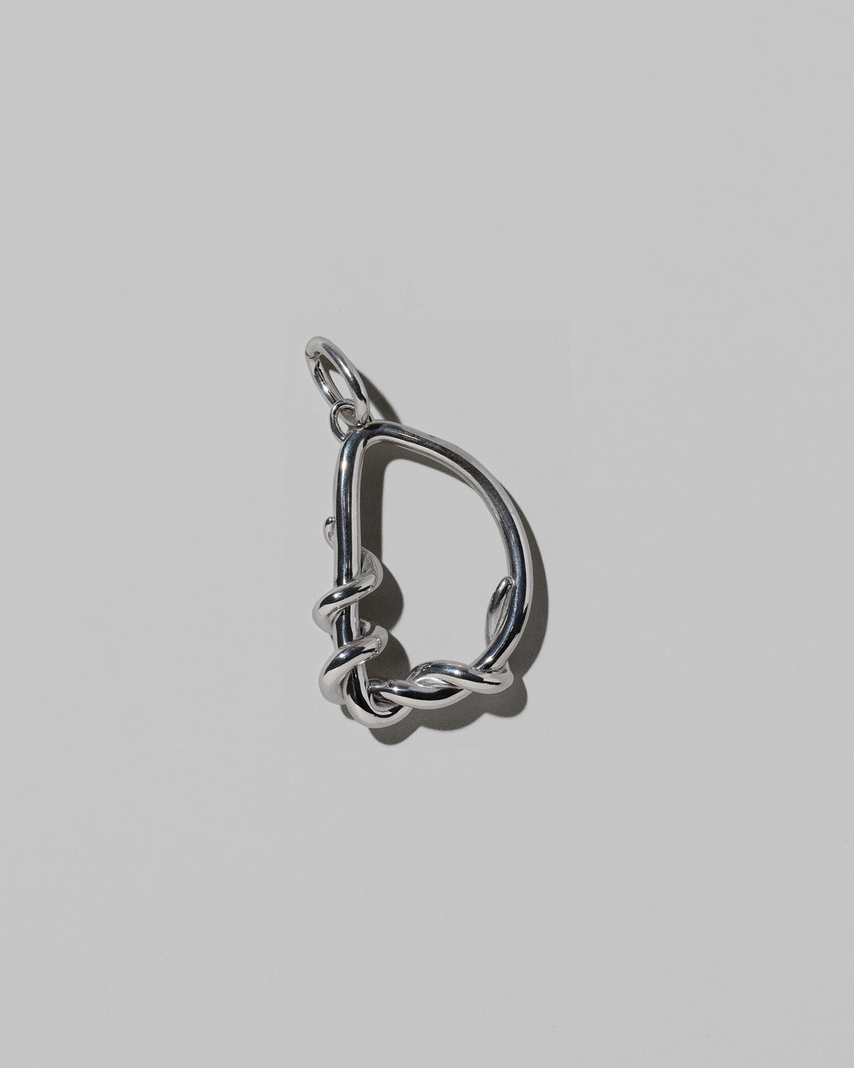 CRZM Large Letter D Charm set in sterling silver on light color background.