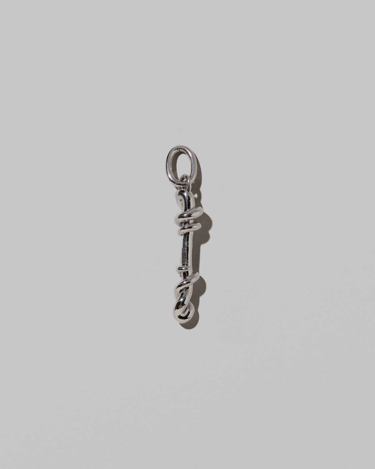 CRZM Large Letter I Charm set in sterling silver on light color background.