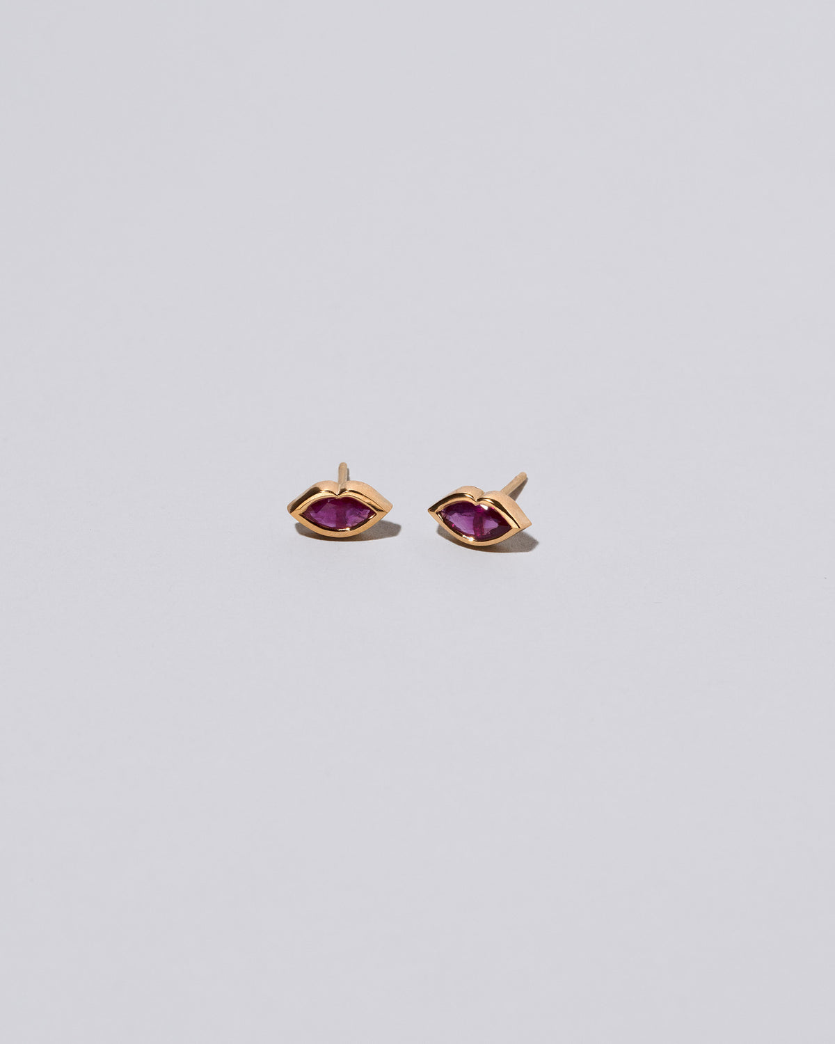 Magenta Big Kiss Stud Earrings on light color background.