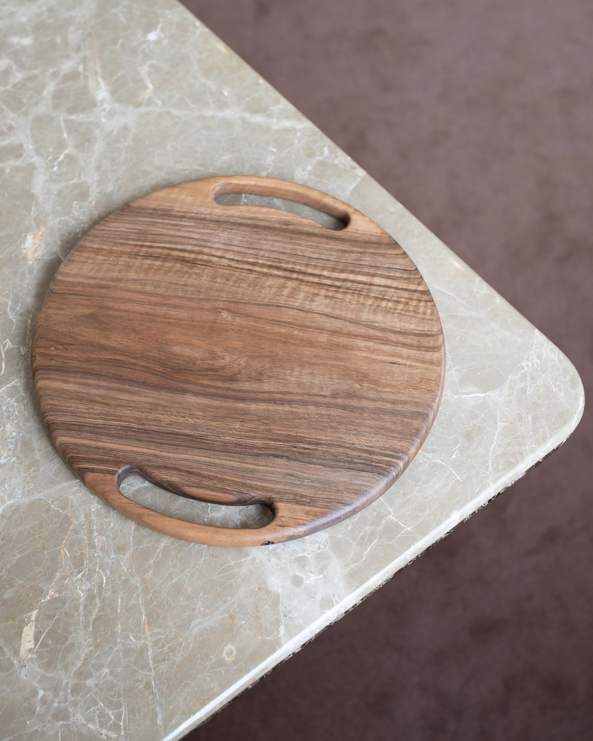 Styled image featuring the Lucas Castex No. 08 Hand-Carved Walnut Wood Serving Board.