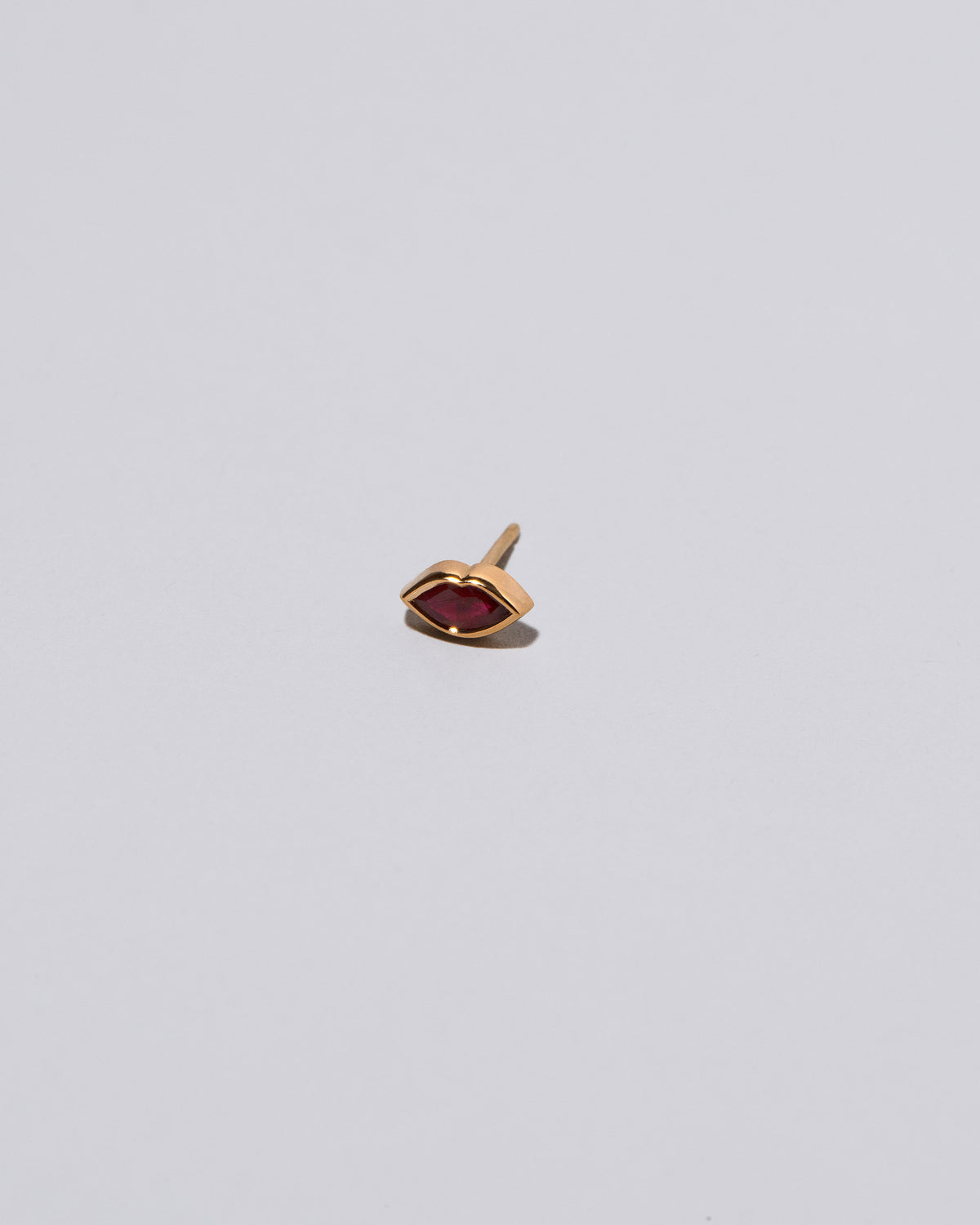 Red Kiss Stud Earring Single on light color background.