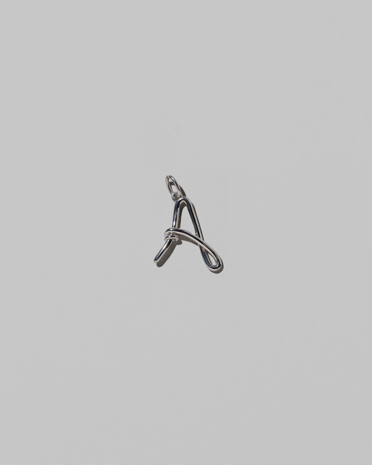 CRZM Medium Letter A Charm set in sterling silver on light color background.