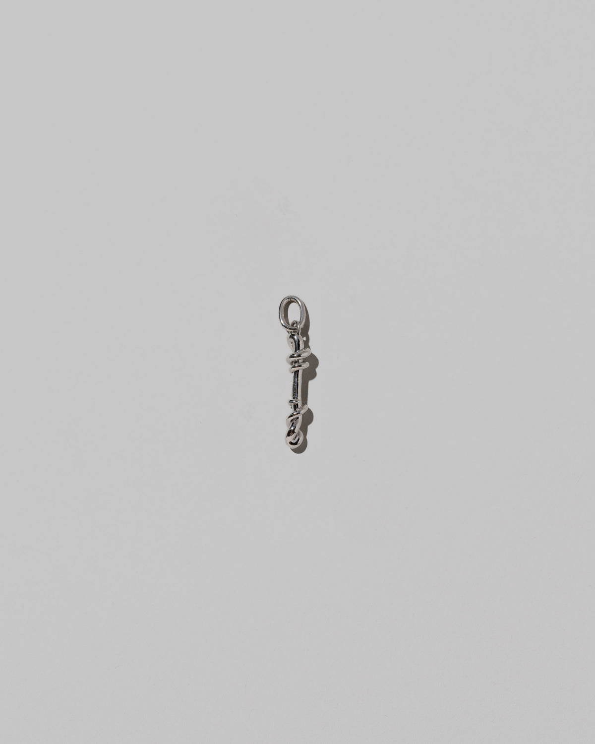 CRZM Medium Letter I Charm set in sterling silver on light color background.
