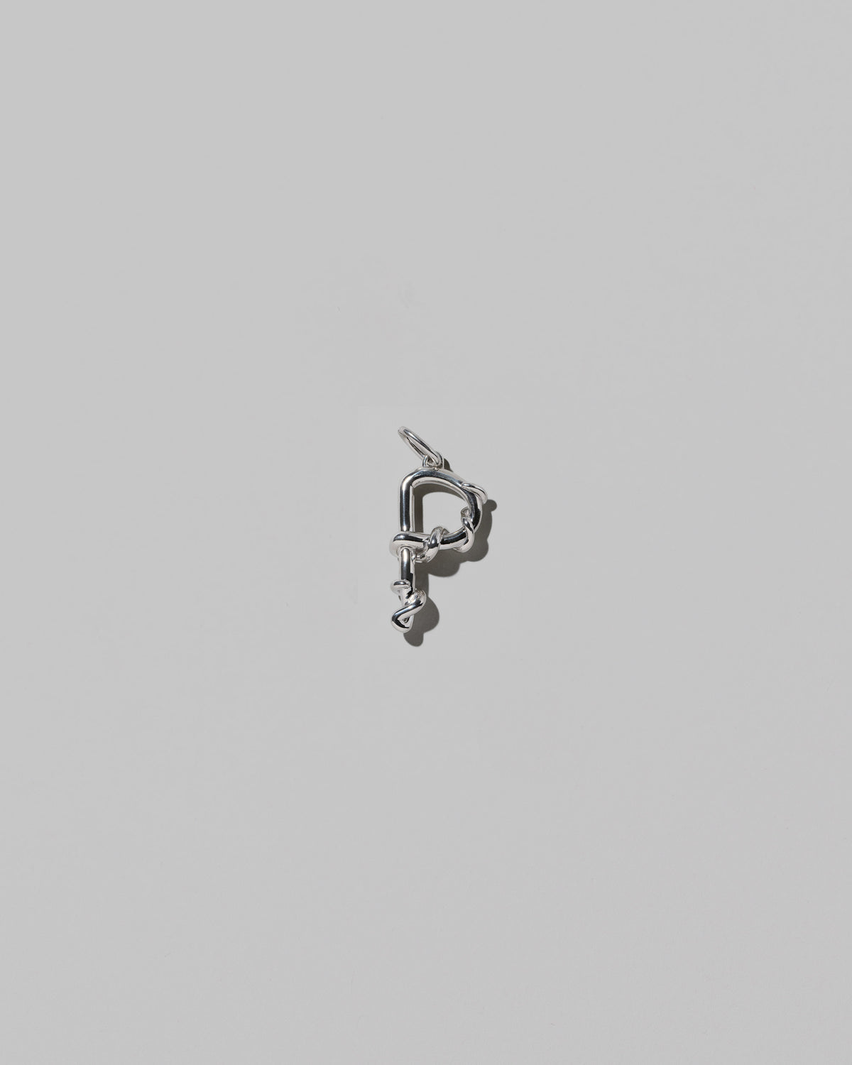 CRZM Medium Letter P Charm set in sterling silver on light color background.