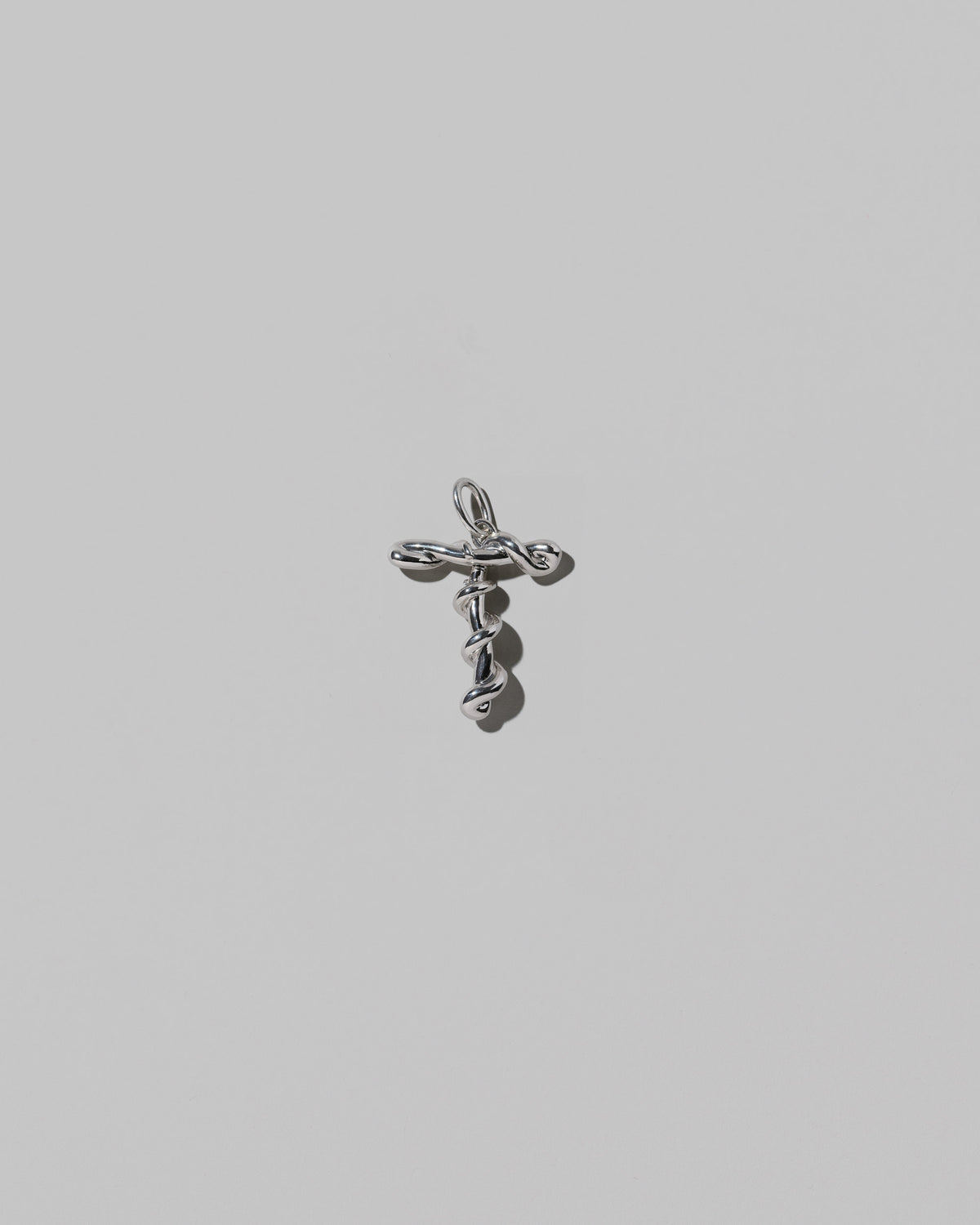 CRZM Medium Letter T Charm set in sterling silver on light color background.