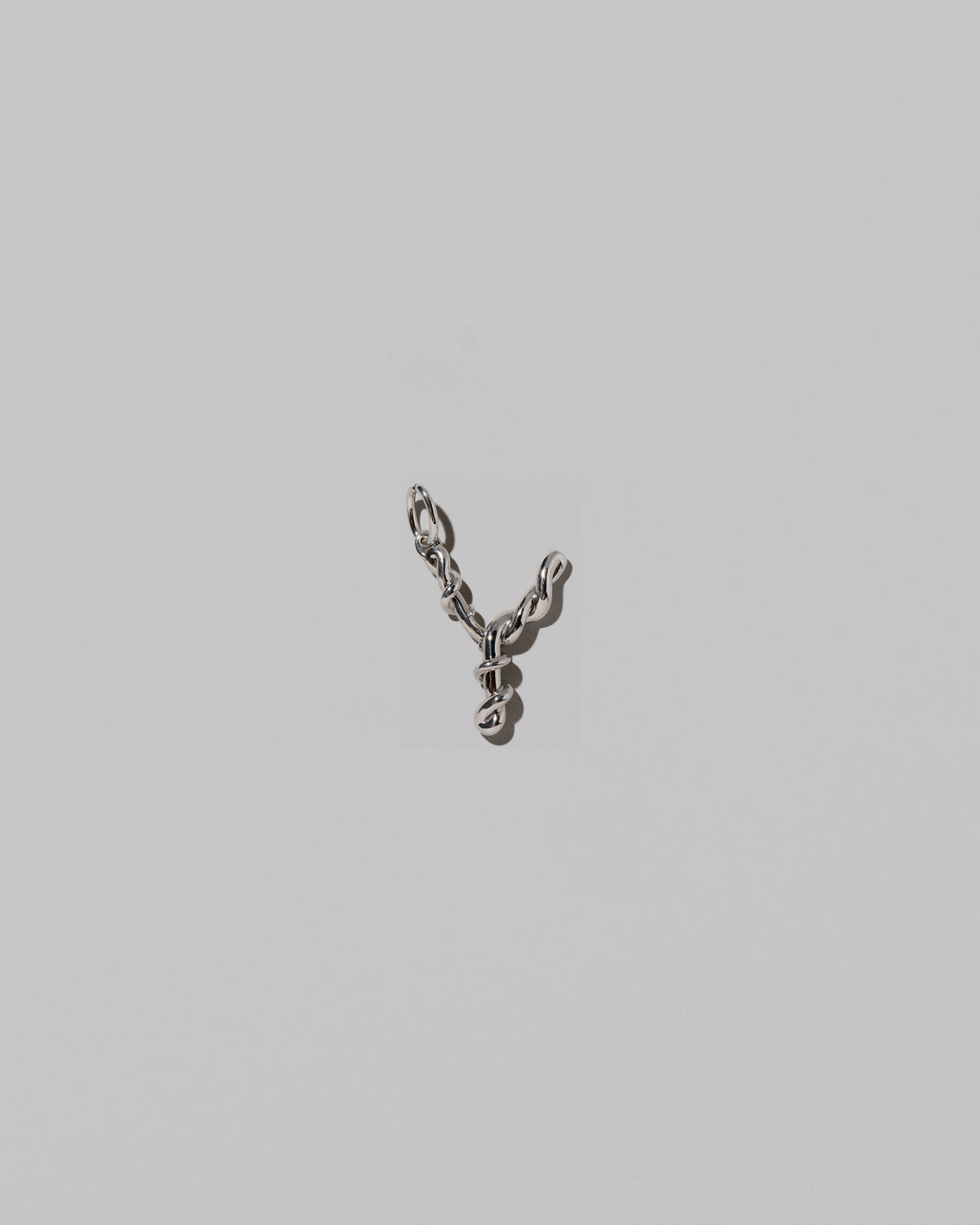 CRZM Medium Letter Y Charm set in sterling silver on light color background.