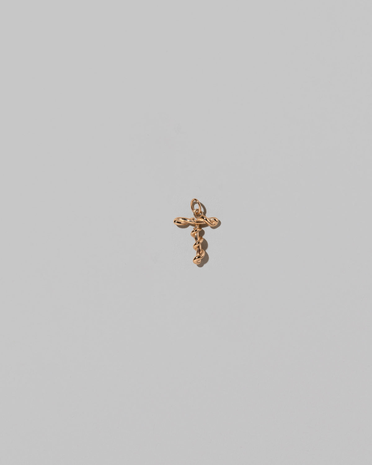 CRZM Mini Letter T set in solid gold on light color background.
