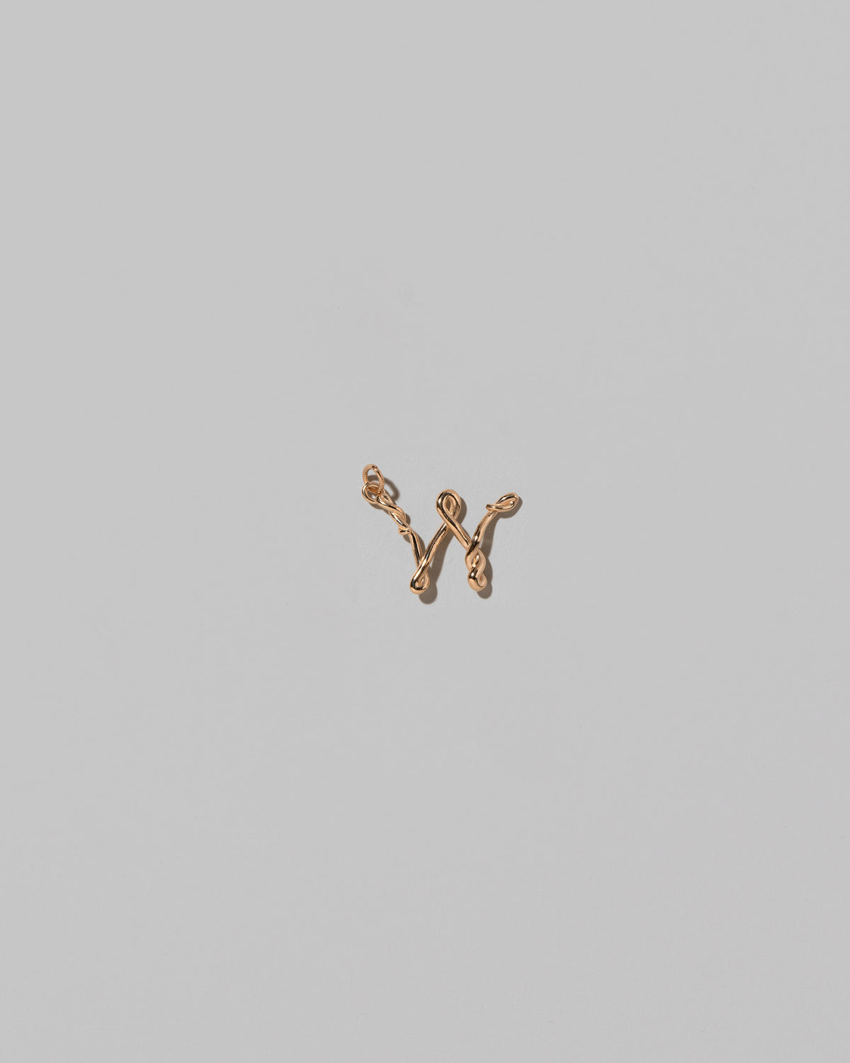 CRZM Mini Letter W set in solid gold on light color background.