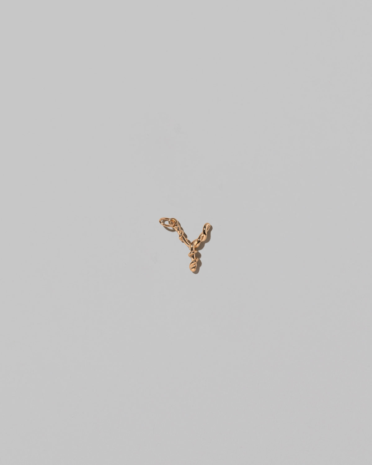 CRZM Mini Letter Y set in solid gold on light color background.