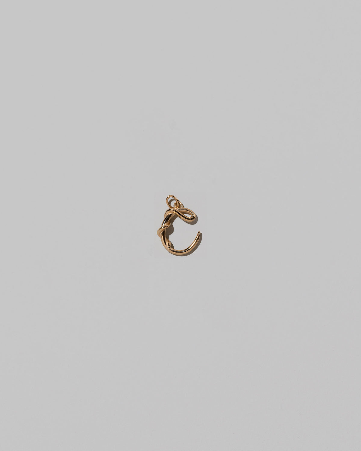CRZM Mini Letter C set in solid gold on light color background.