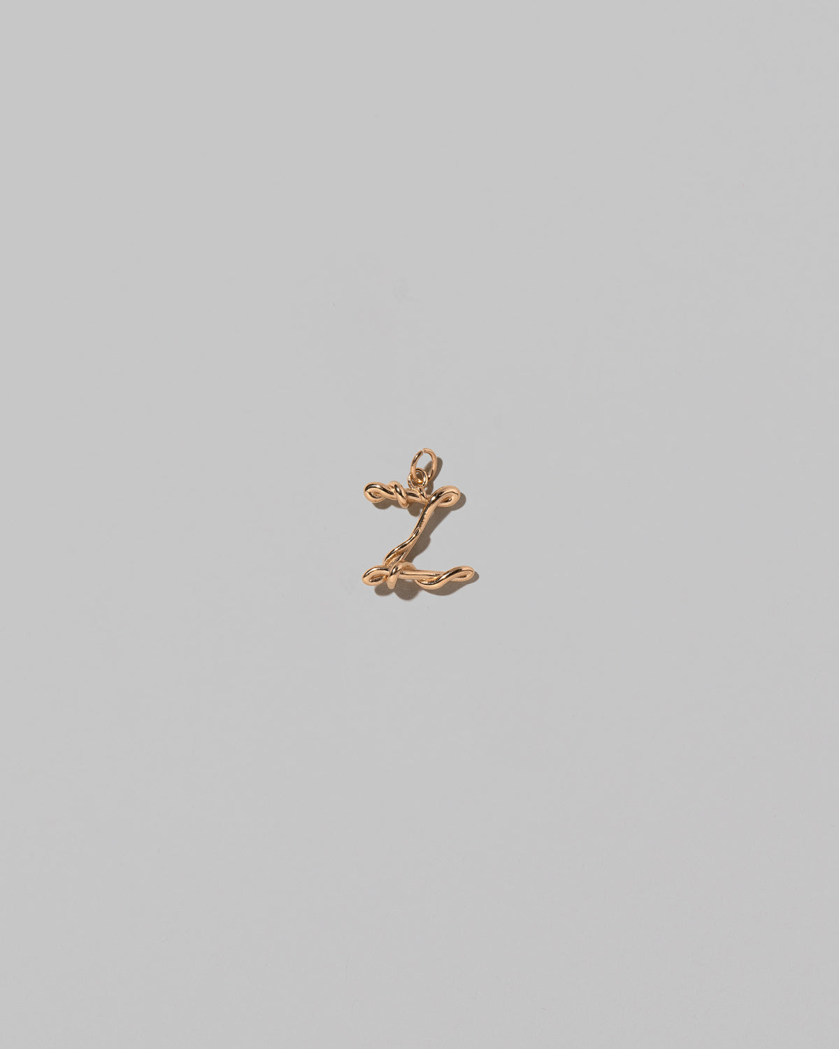 CRZM Mini Letter Z set in solid gold on light color background.