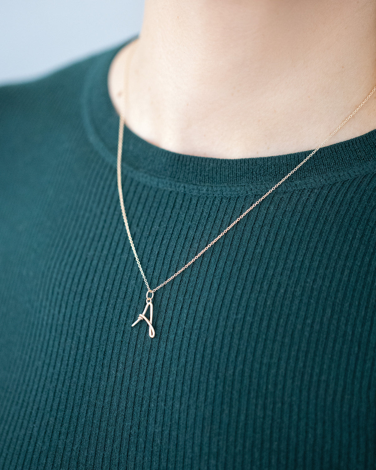 CRZM Mini Letter A and Cable Chain set in solid gold on model.