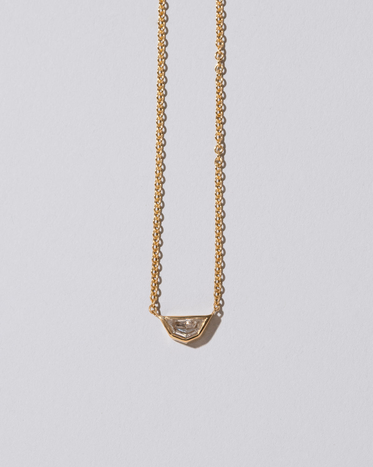 Closeup details of the Adamas Necklace on light color background.