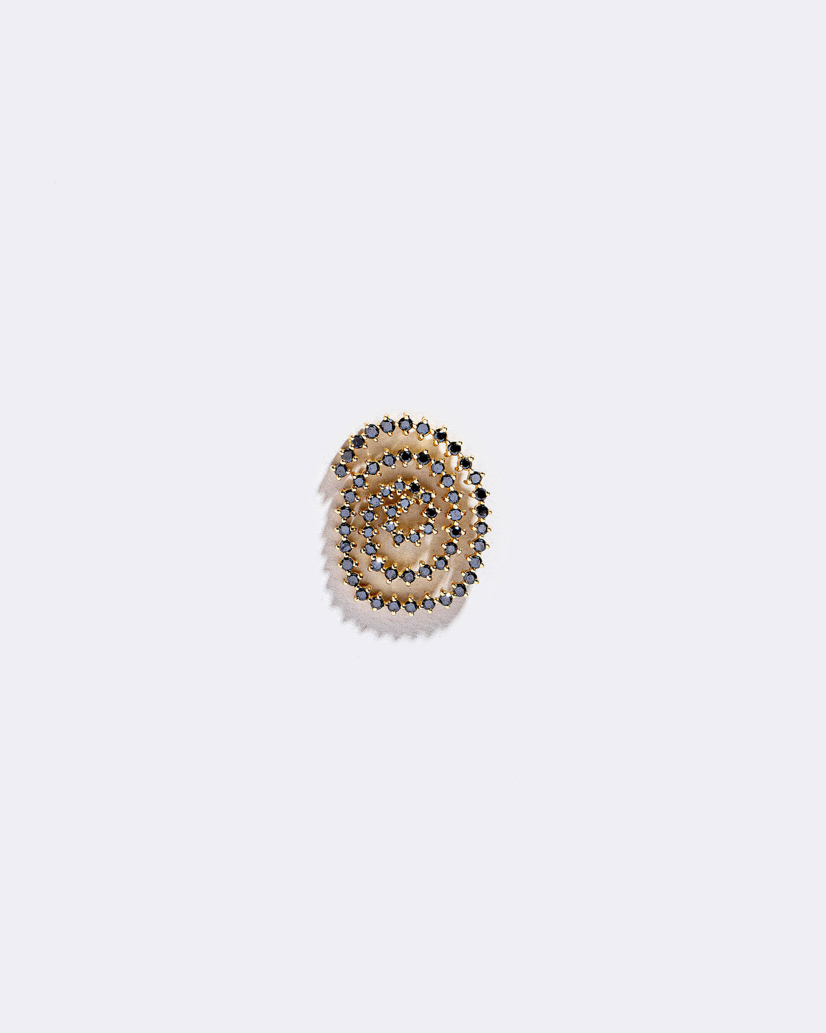 Left Black Diamond Cycle of Rebirth Earring Single on light color background.