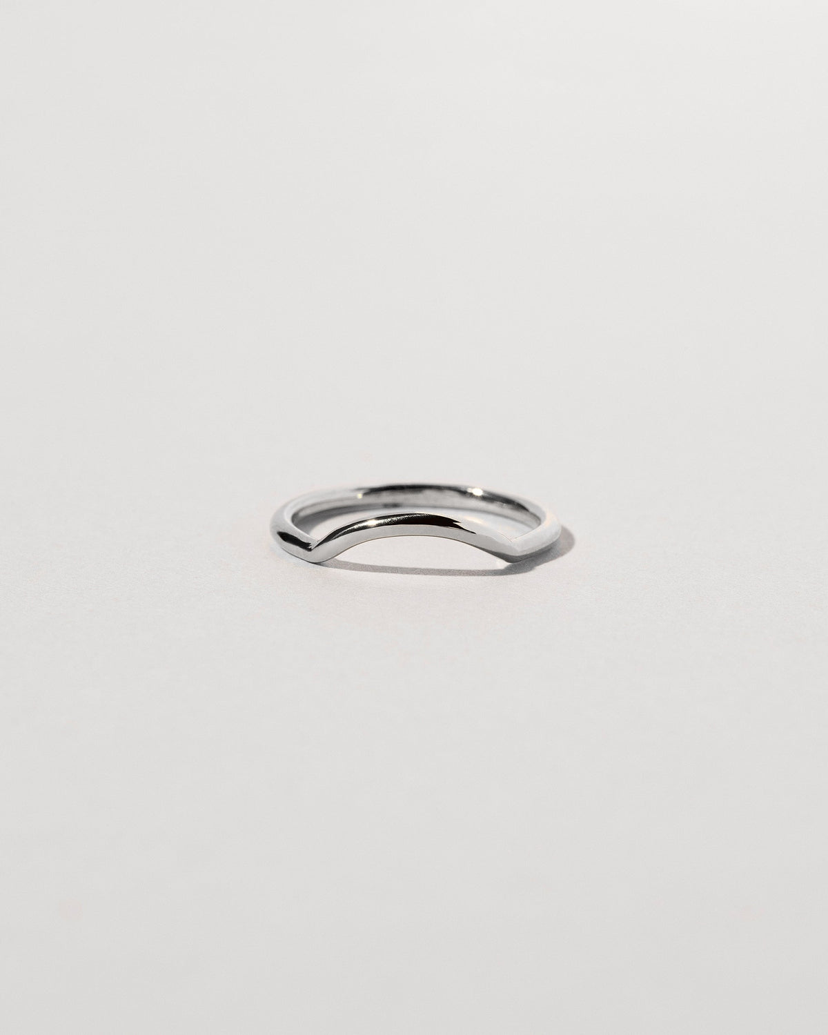 Platinum Solid Round Wire Mini Curve Band on light color background.