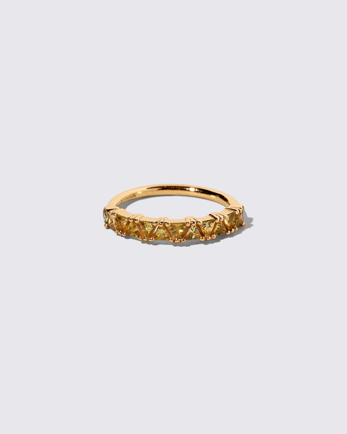 Yellow Sapphire Eleven Trillion Ring on light color background.