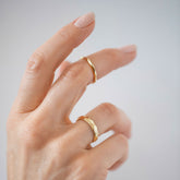 product_details::Gold 4mm Facet Band and Gold 2mm Facet Band on model.