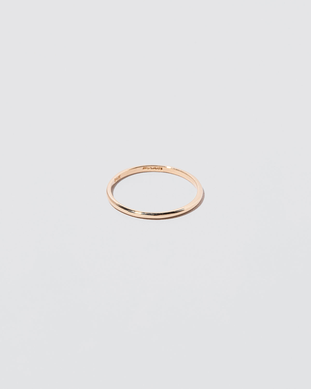 Details view of the Gold 1mm Half Round Band on light color background.
