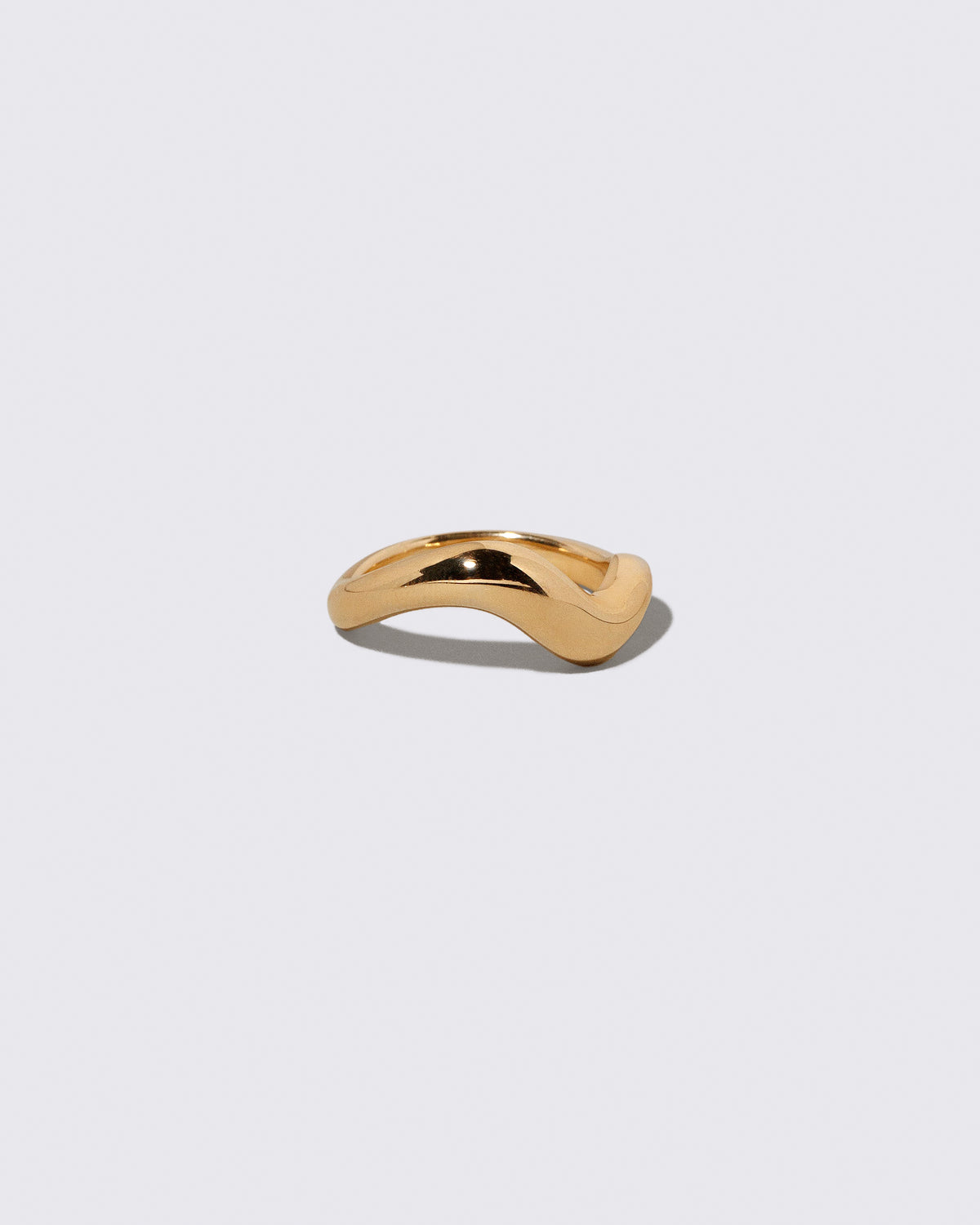 View from the side of the Gold Unbroken Band on light color background.
