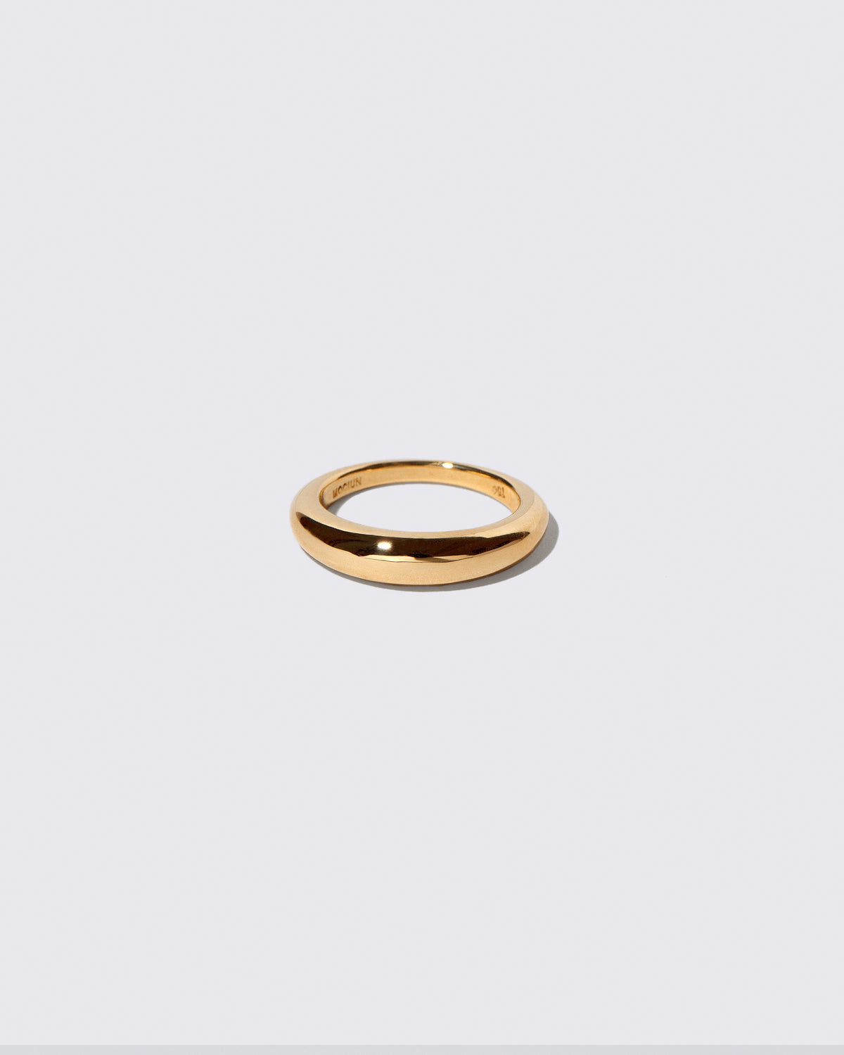Gold 4.5mm Venus Band on light color background.