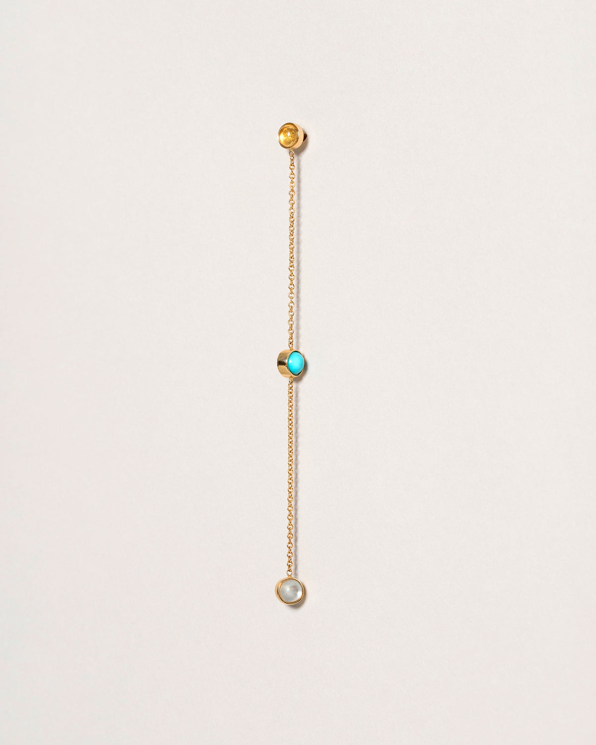 Birthstone Two-Drop Single Earring on light color background.
