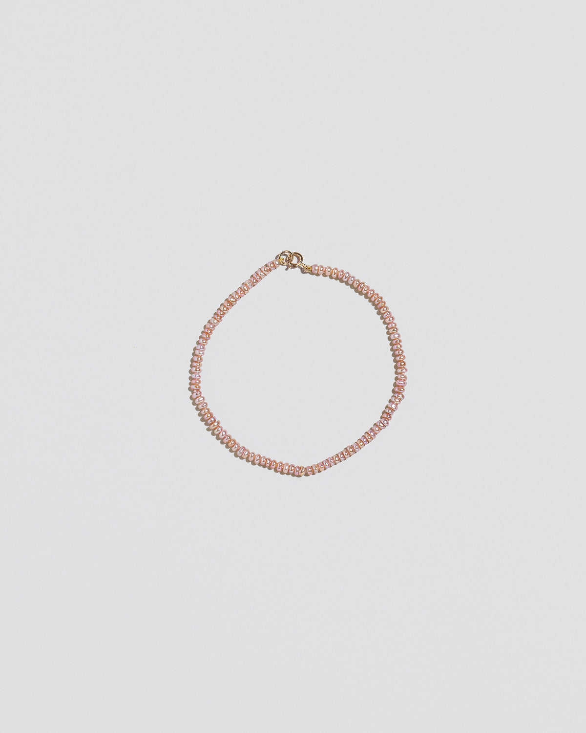 Pink Peony Lavender Seed Pearl Bracelet on light color background.