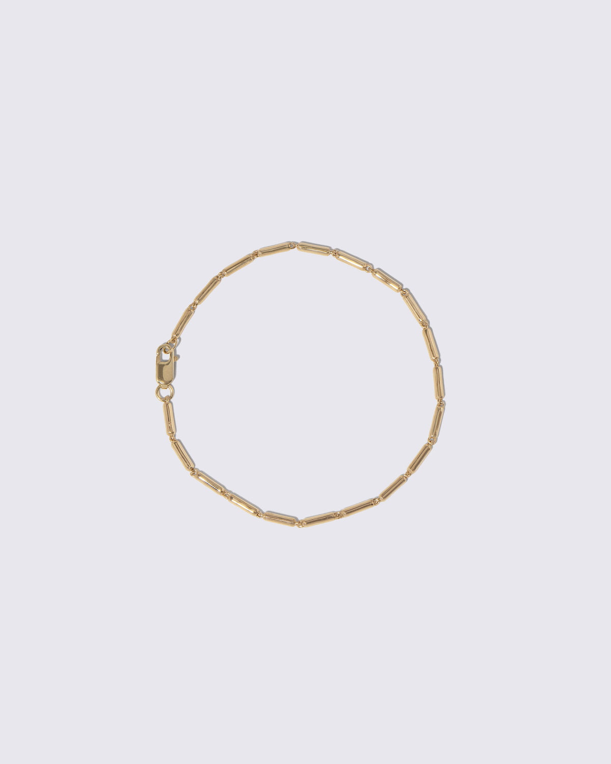 Gold Butter Chain Bracelet on light color background.