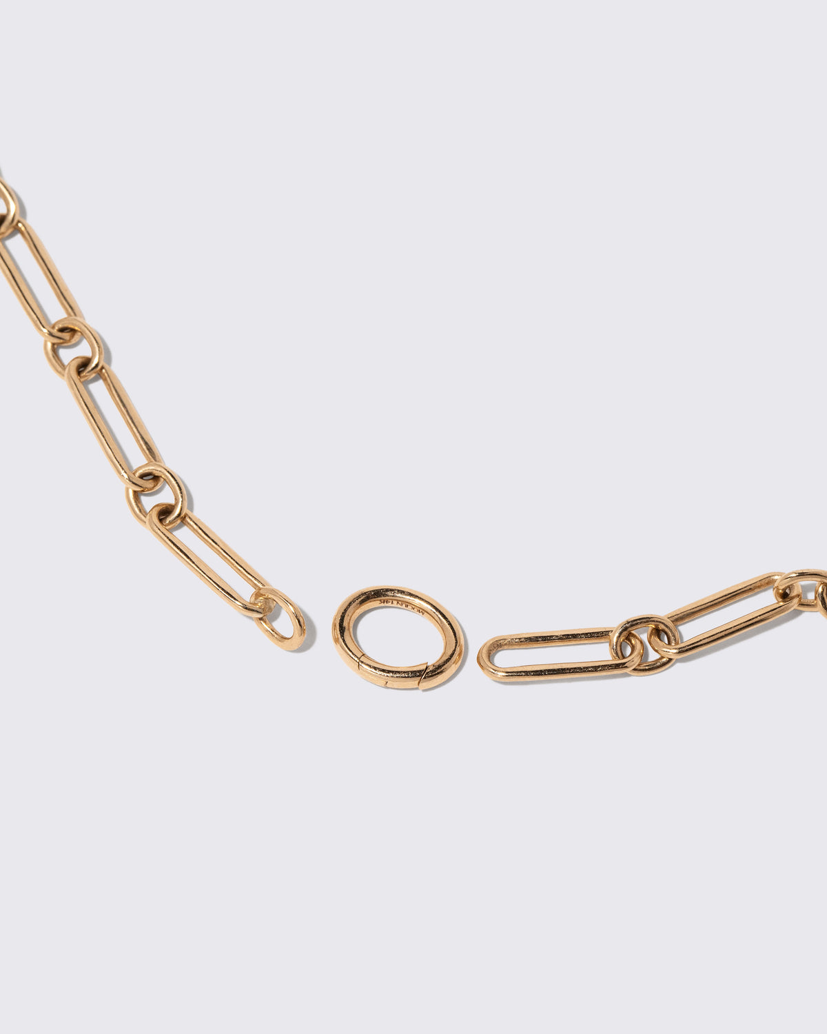 Detail view of the detachable Mociun Oval Openable Link closure on the Petite Link Bracelet on light color background.