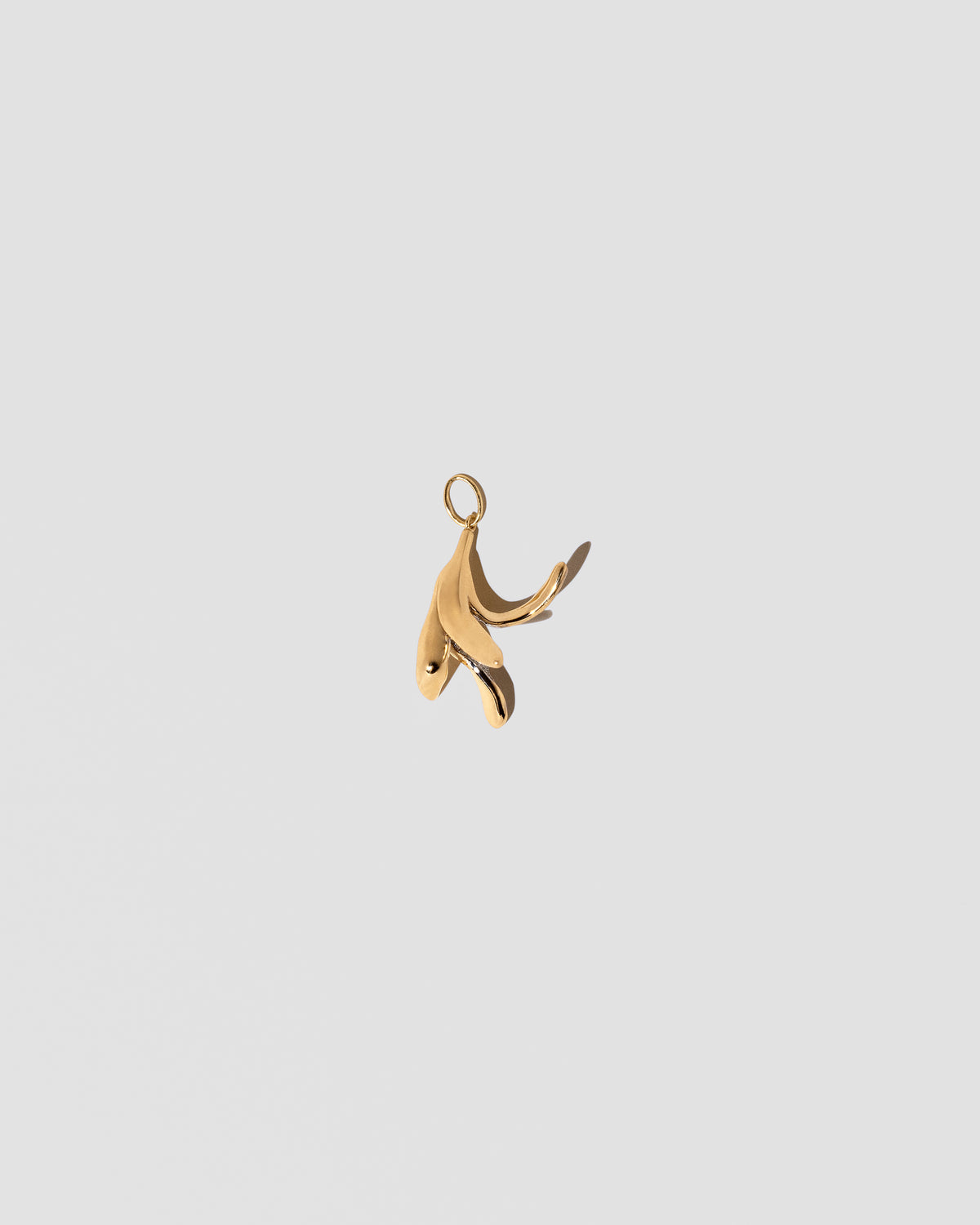 View from the back of the Banana Peel Charm on light color background.