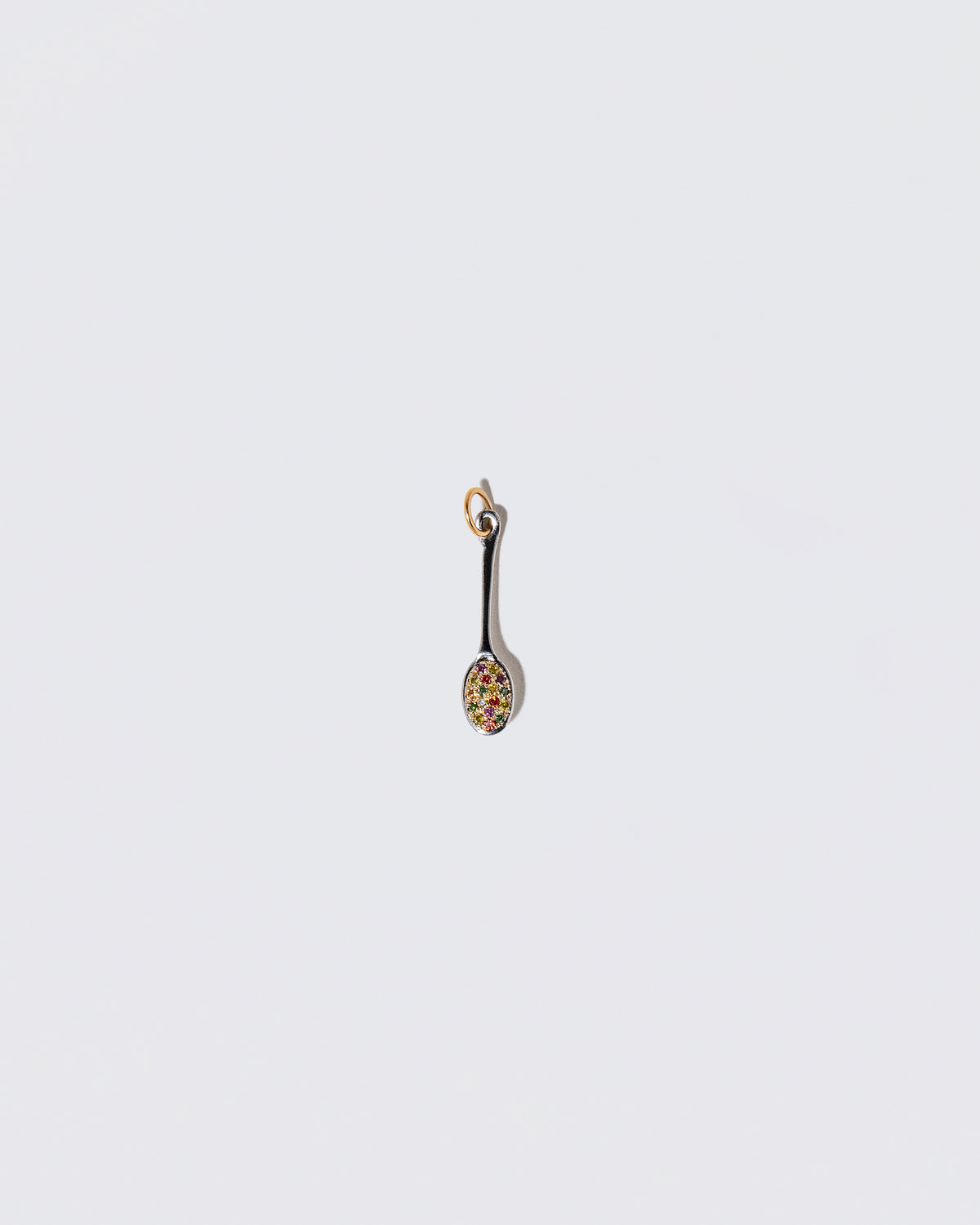 Cereal Spoon Charm on light color background.