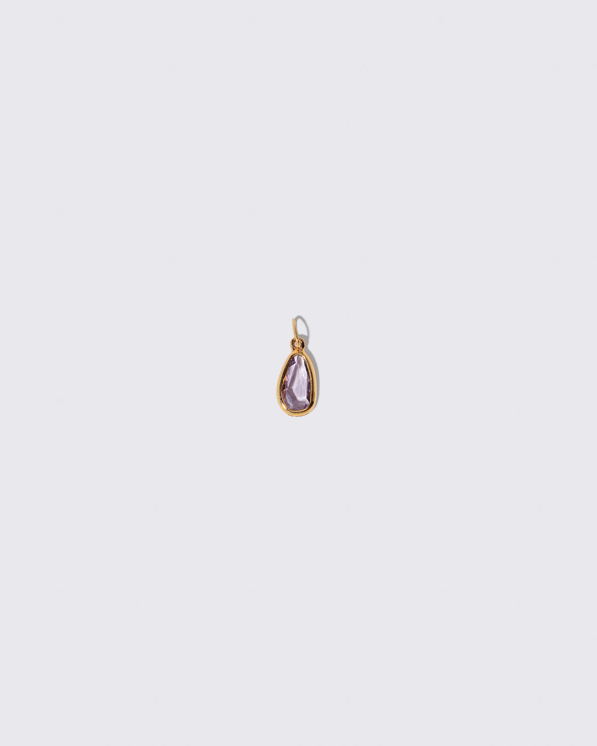 Purple Sapphire Gusher Charm on light color background.