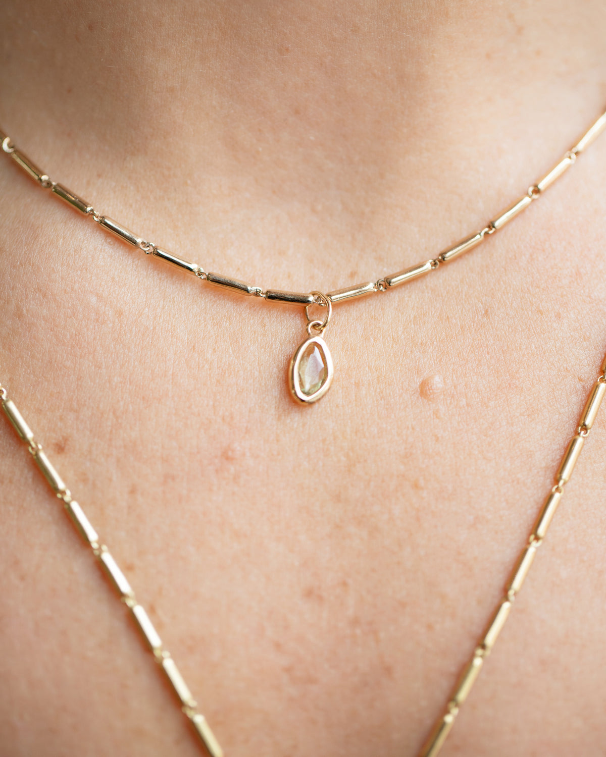 Yellow Sapphire Gusher Charm and Gold Butter Chain Necklace on model.