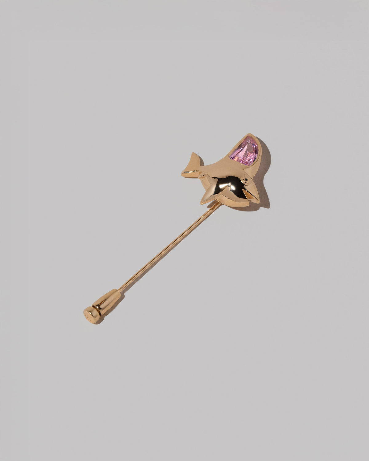 View from the side of the Simon Shark Pin on light color background.