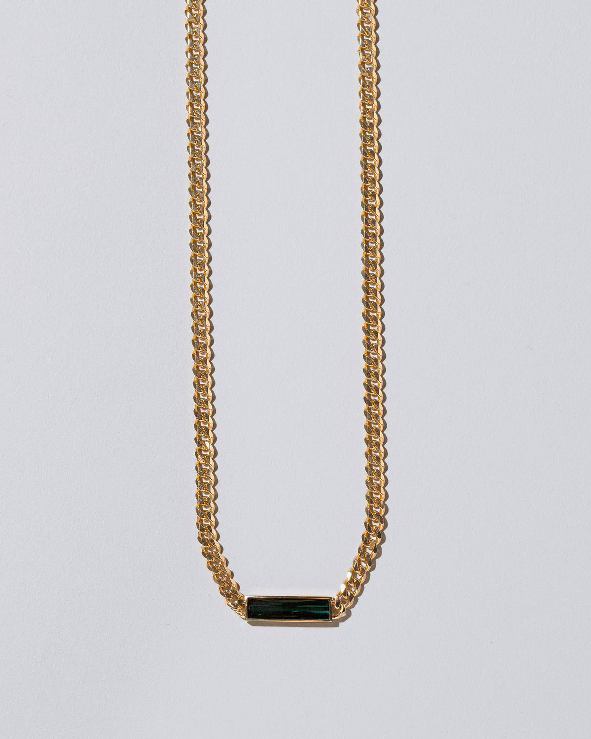 Closeup details of the Generosity Necklace on light color background.
