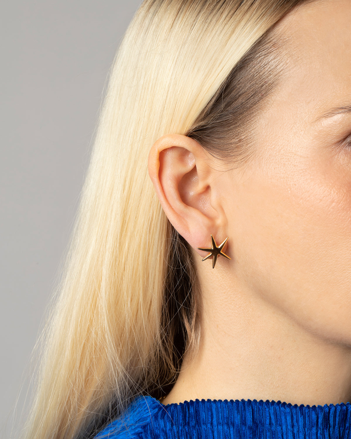 Gold Large Verve Six Point Star Stud Earrings on model.