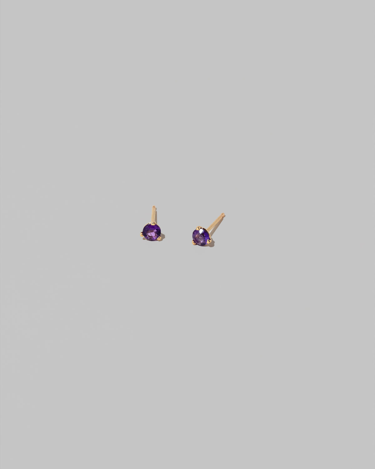 Petite Amethyst Martini Stud Earrings on light color background.