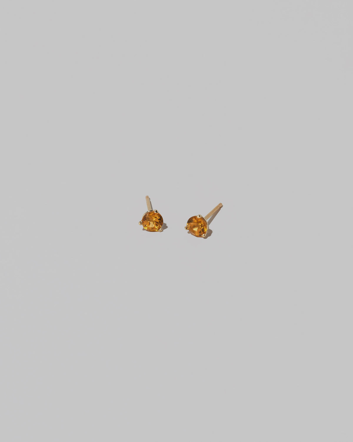 Citrine Martini Stud Earrings on light color background.