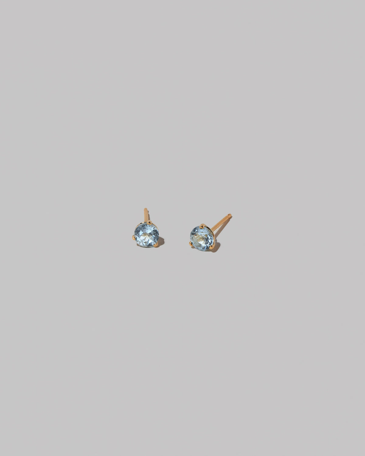 Grand Aquamarine Martini Stud Earrings on light color background.