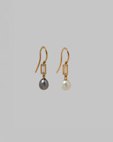 View from the side of the Poseidon Earrings on light color background.
