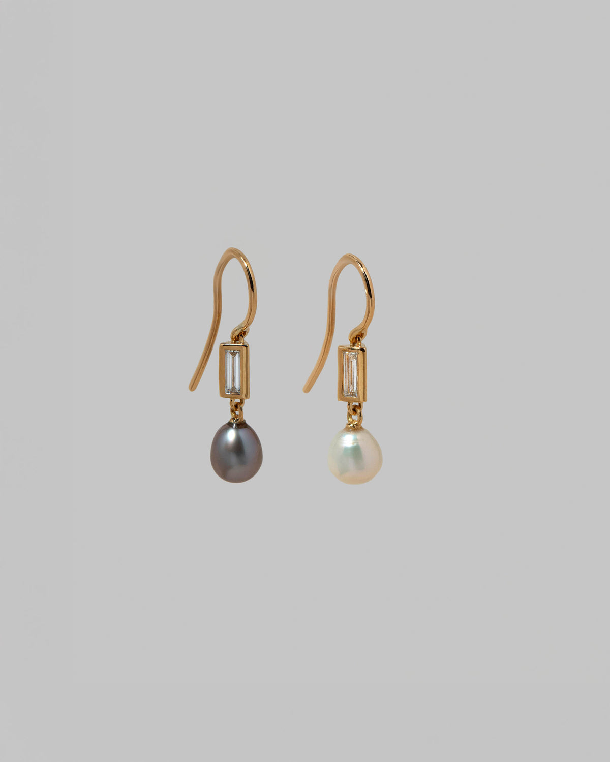 View from the side of the Poseidon Earrings on light color background.