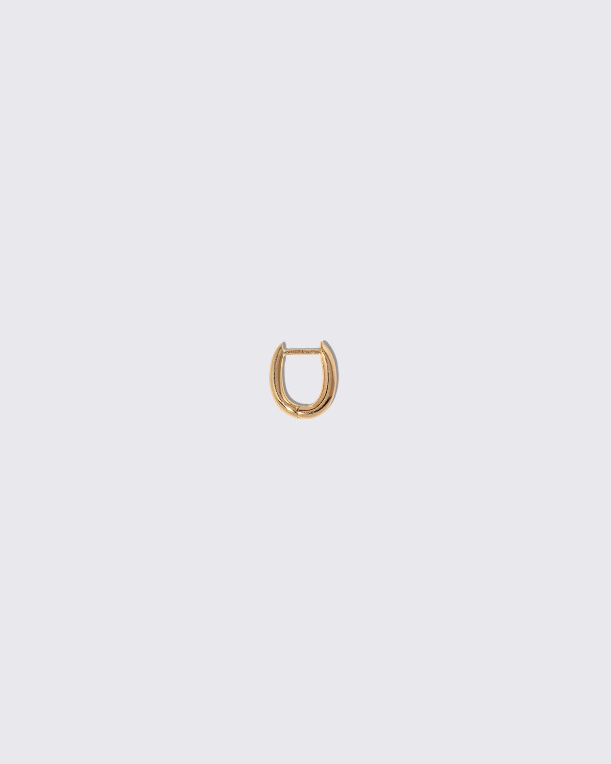 Styling Huggie Hoop Earring Single on light color background.