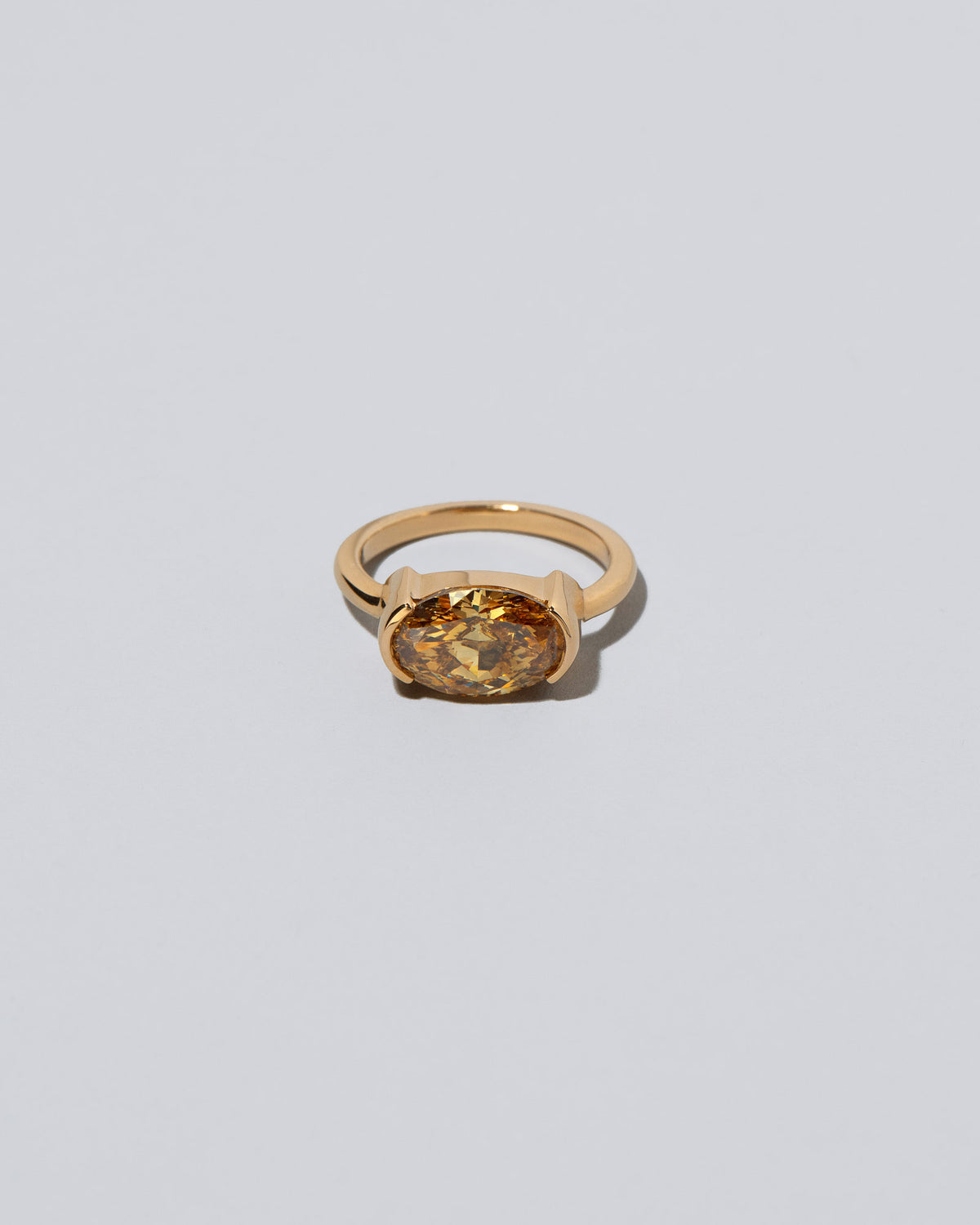 Exhilaration Ring on light color background.
