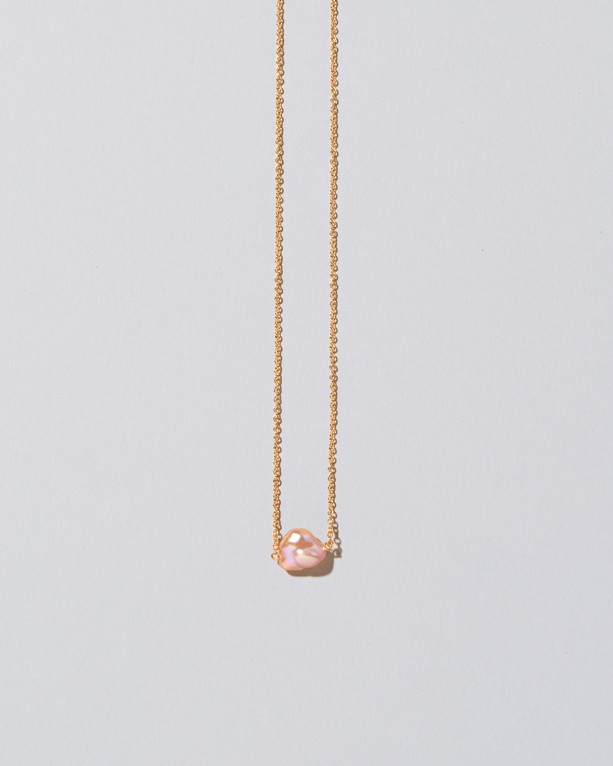 Blush Pink Lagniappe Pearl Necklace on light color background.