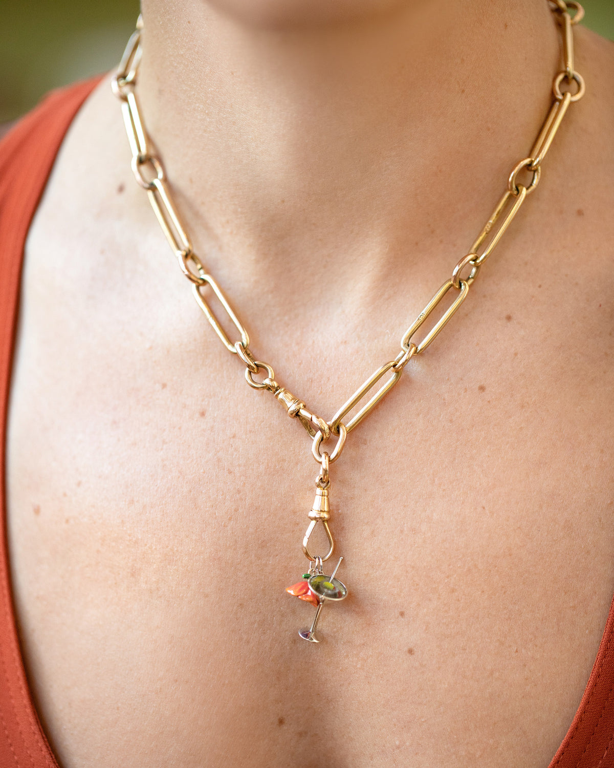 California Poppy Charm, Dirty Martini Charm and Luna Ring Charm paired with the Grand Swivel Fob and Solid Link Necklace on model.