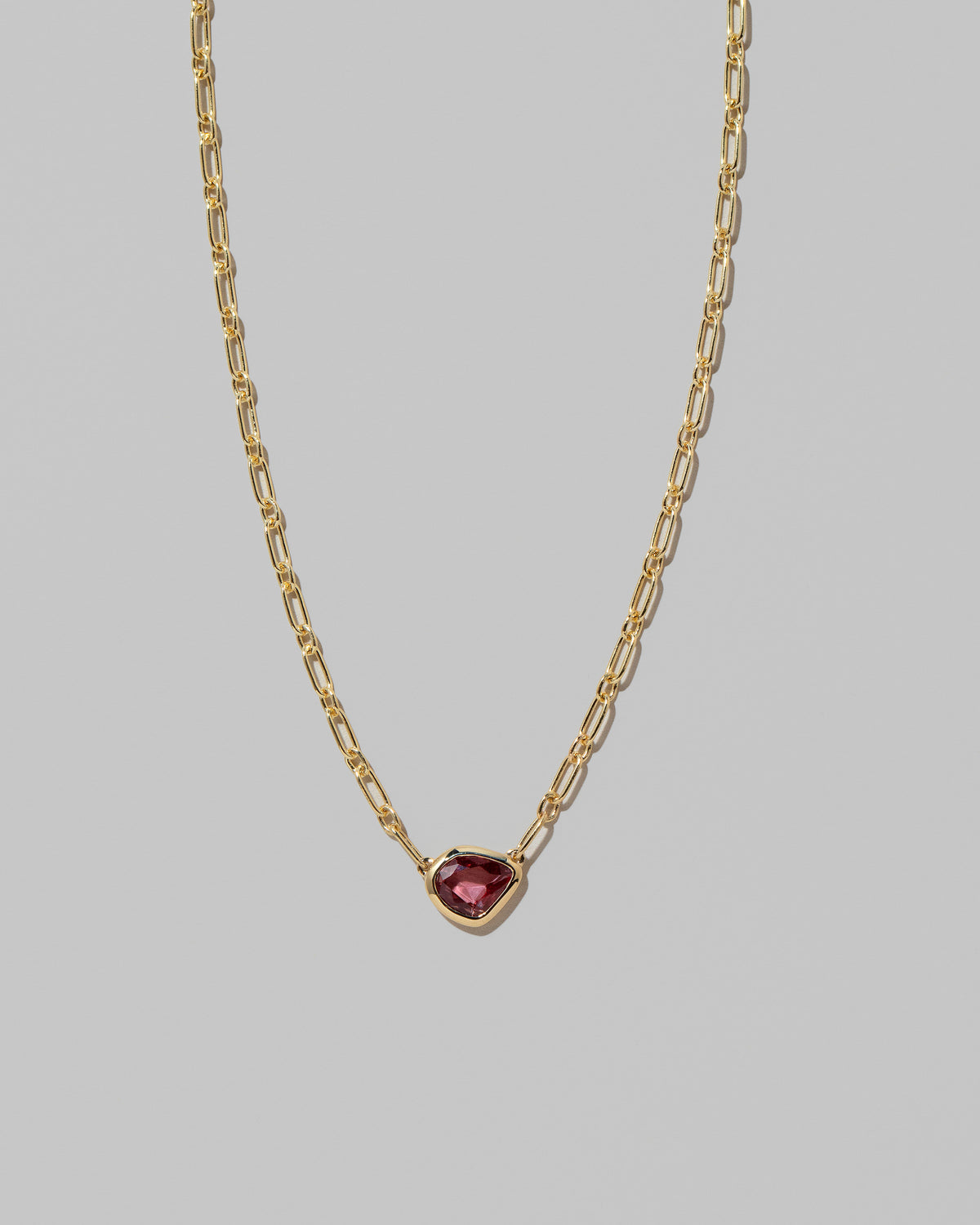 Closeup details of the Pink Sapphire Gusher Necklace on light color background.