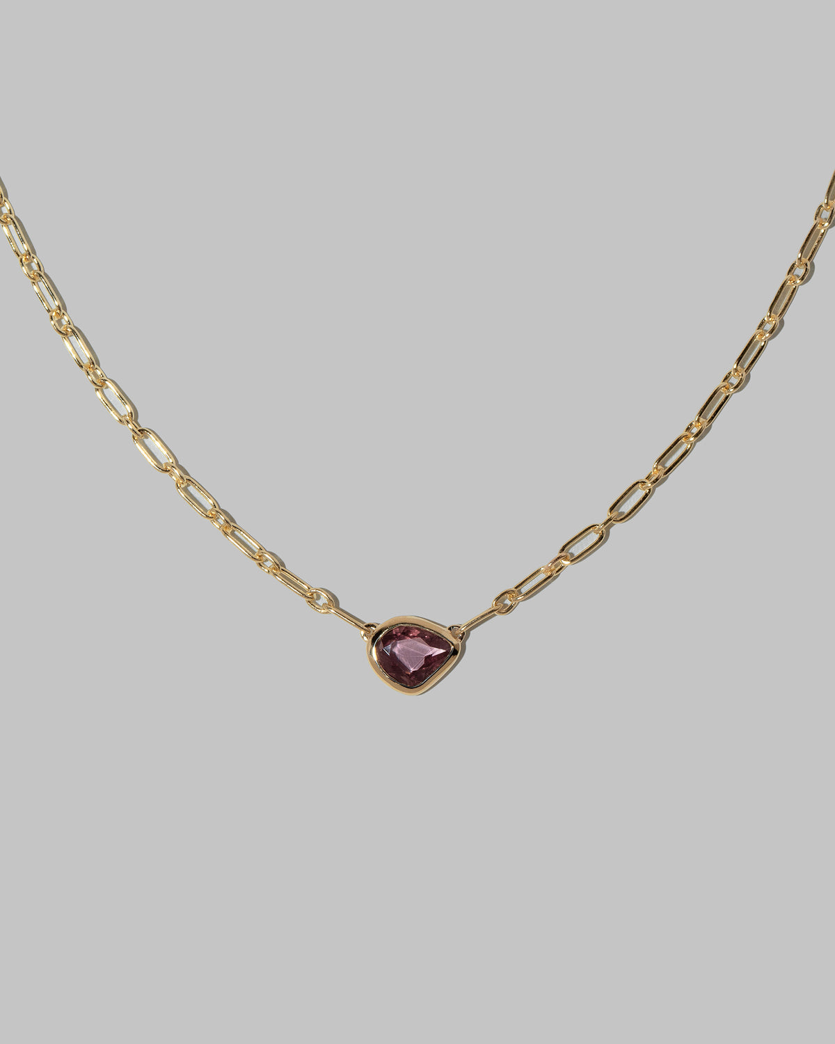 Closeup details of the Pink Sapphire Gusher Necklace on light color background.