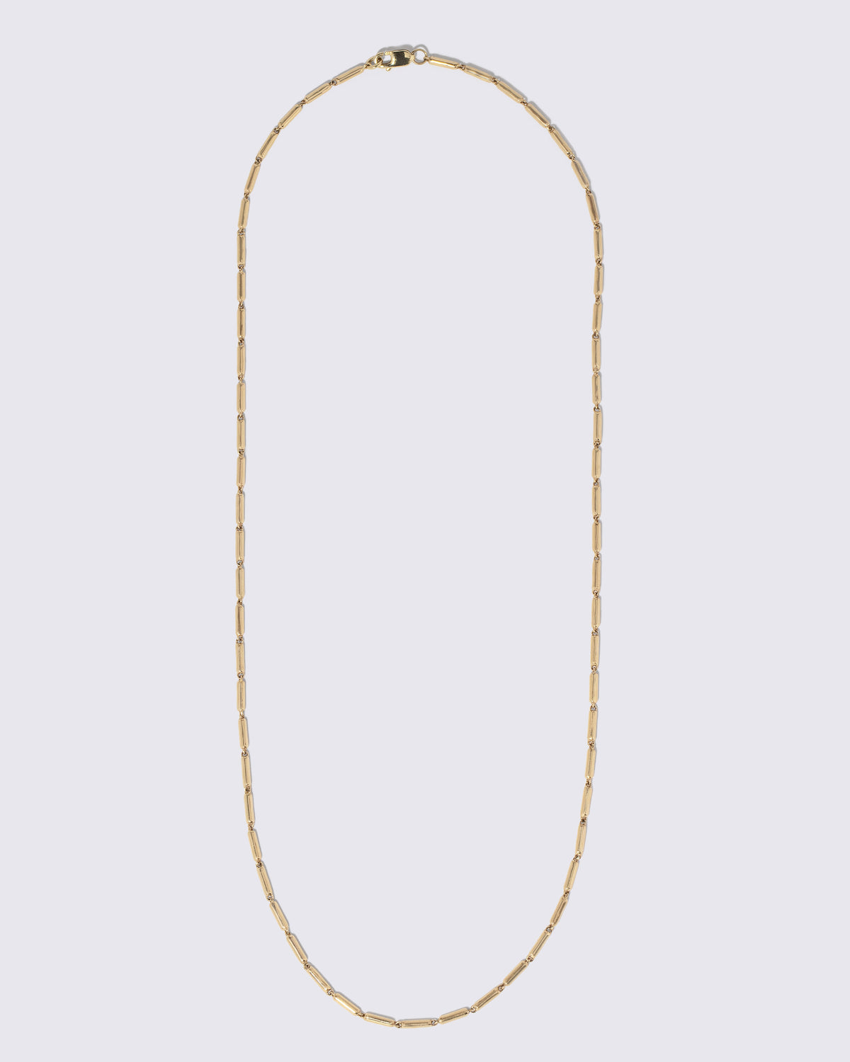Gold Butter Chain Necklace on light color background.