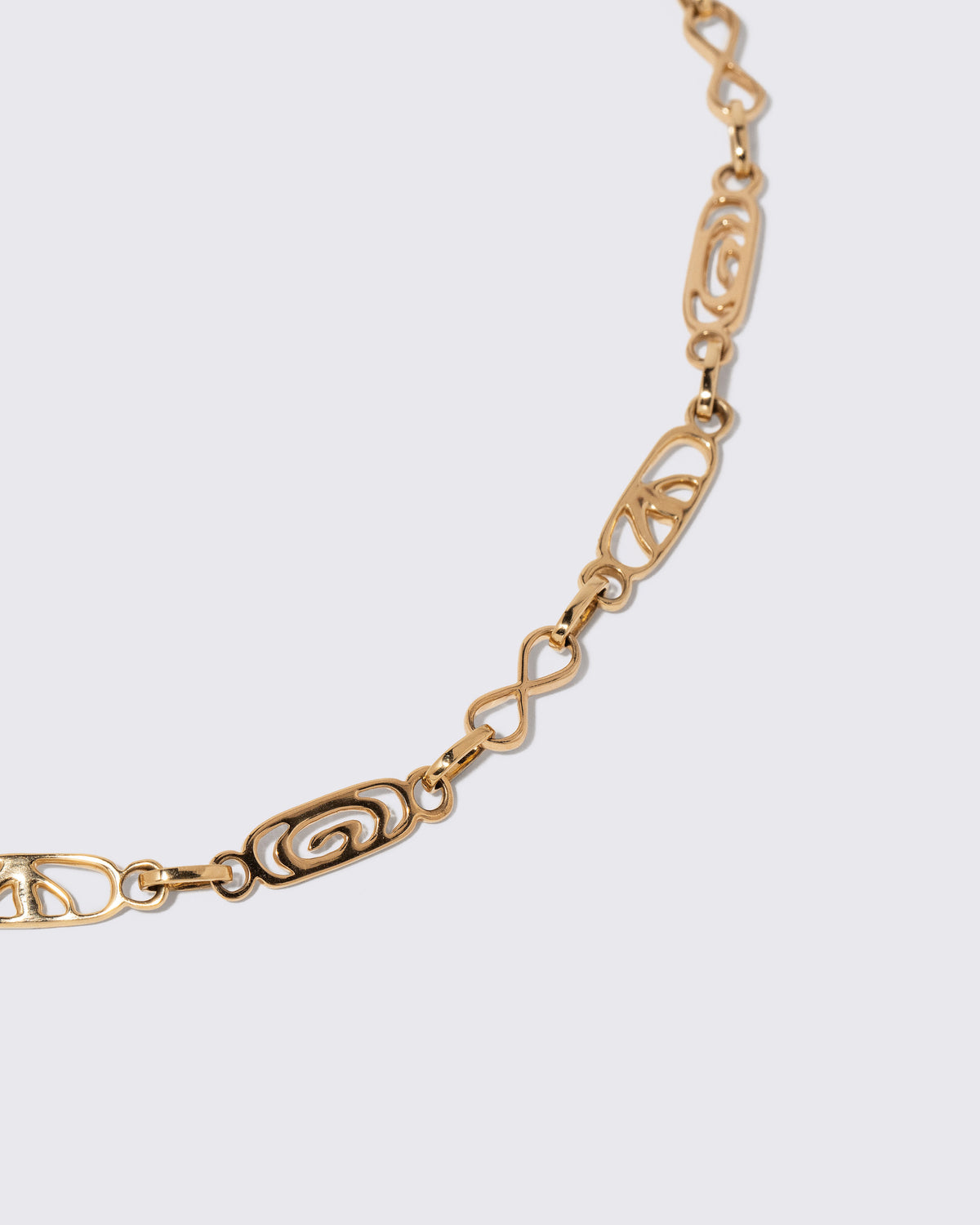 Closeup details of the Infinity Openable Link Necklace on light color background.