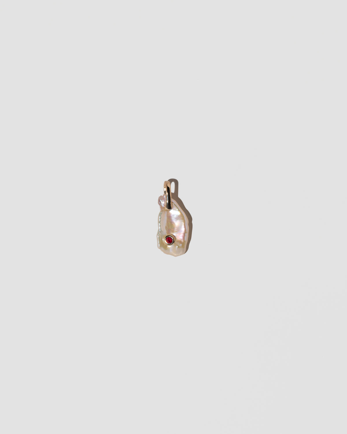 January Birthstone Pearl Pendant With Garnet on light color background.